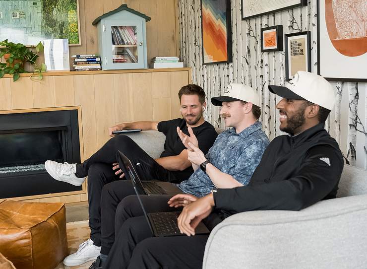 Scroll team talking on a couch in the office